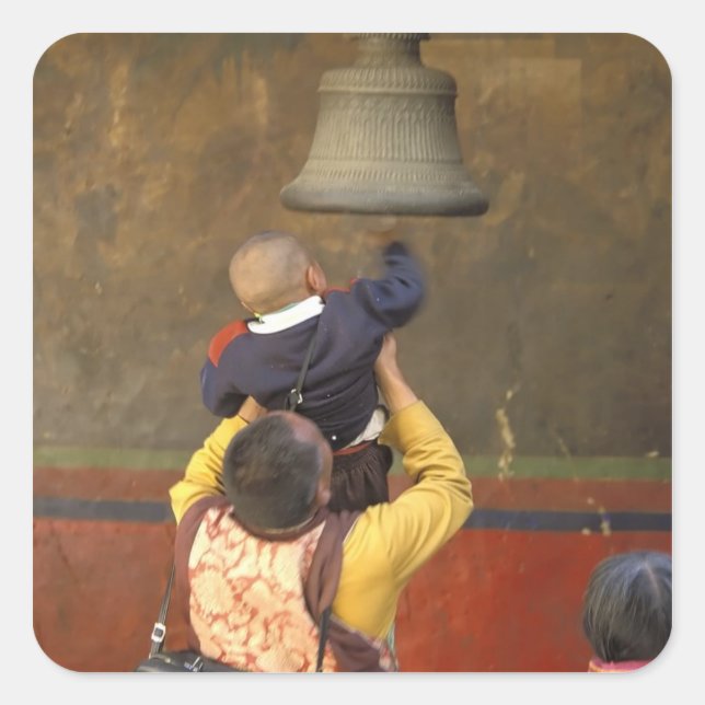 Tibetan Buddhist monk lifting a boy to ring a Square Sticker (Front)