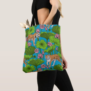 Tigers in the pink lotus pond tote bag