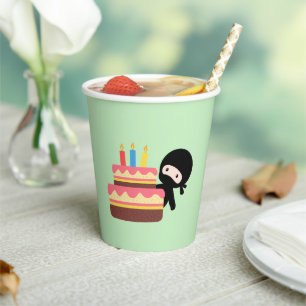 Tiny Ninja Behind Birthday Cake on Green Paper Cups