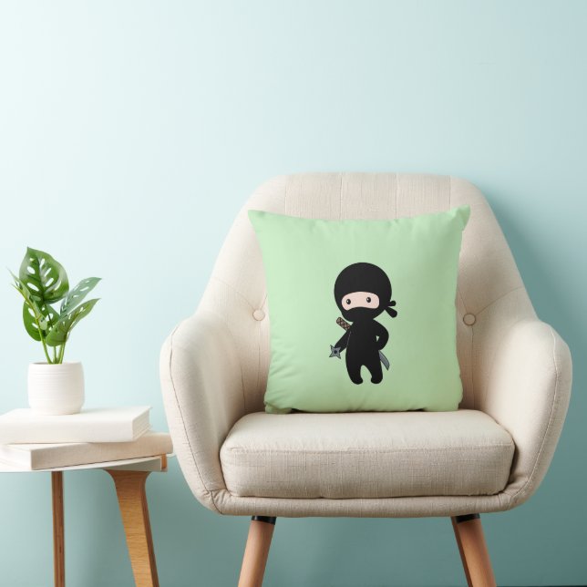 Tiny Ninja Holding Throwing Star On Green Cushion (Chair)