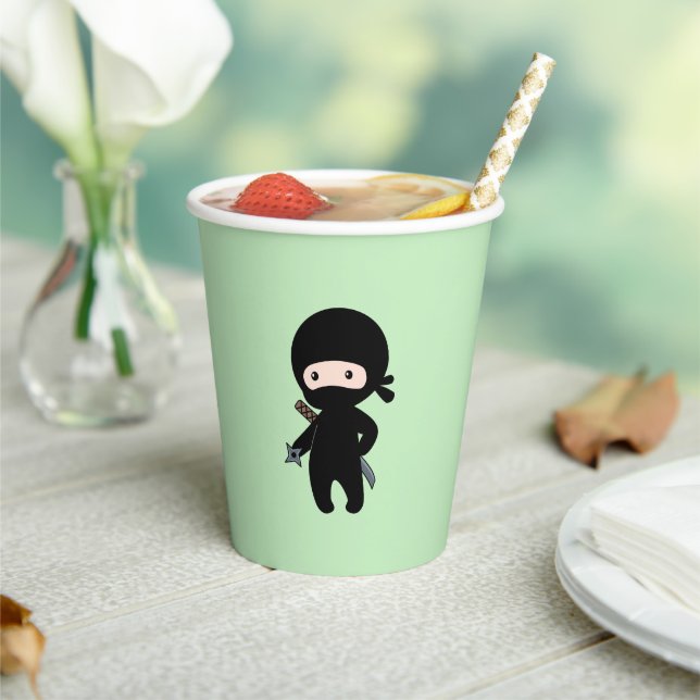 Tiny Ninja Holding Throwing Star on Green Paper Cups (Insitu)