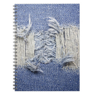 Torn blue denim: jeans texture. notebook