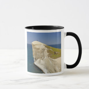 Tourists on cliff top at Tunnel Beach Mug