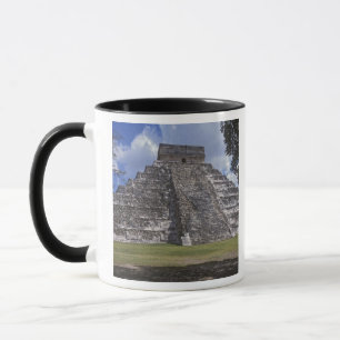 Tourists walk past an unrestored side of El Mug