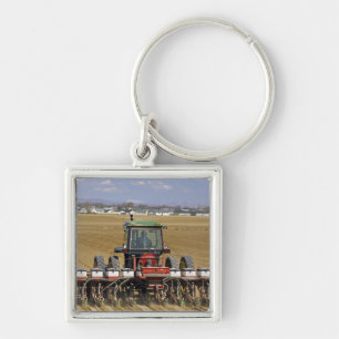 Tractor pulling a seed corn planter. key ring