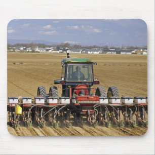 Tractor pulling a seed corn planter. mouse mat