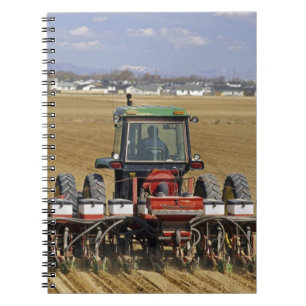 Tractor pulling a seed corn planter. notebook