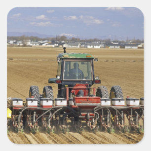 Tractor pulling a seed corn planter. square sticker