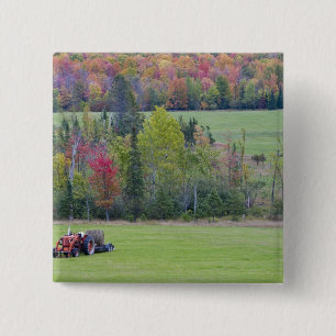 Tractor with hay bale in green field with 15 cm square badge