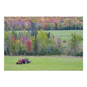 Tractor with hay bale in green field with photo print