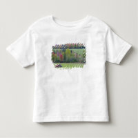 Tractor with hay bale in green field with