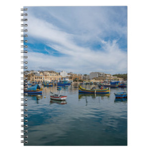 Traditional colorful fishing boats in the harbor notebook