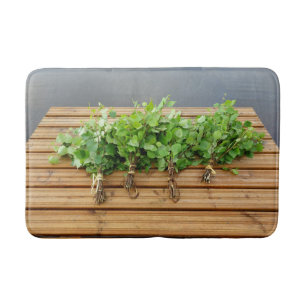 Traditional Finnish bath whisks on a jetty Mat