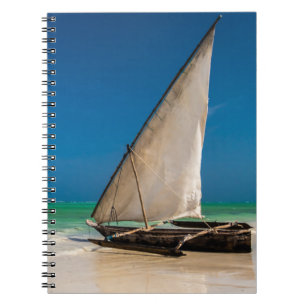 Traditional fishing boat on the beach notebook