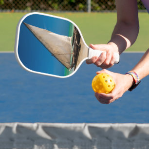 Traditional fishing boat on the beach pickleball paddle