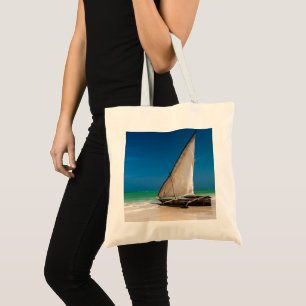 Traditional fishing boat on the beach tote bag