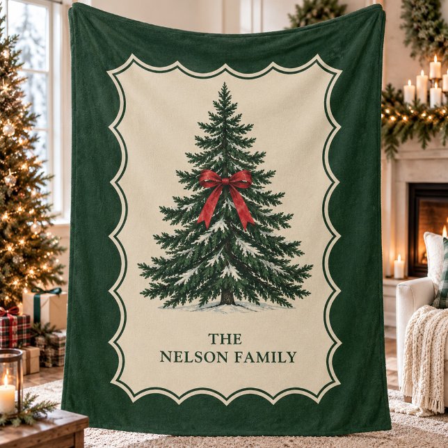 Traditional Pine Tree Alpine Heritage Winter Fleece Blanket (Traditional snow-dusted pine tree with a red bow in a cream scalloped border with family name.)