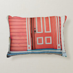 Traditional red painted wooden door and porchdoor, decorative cushion
