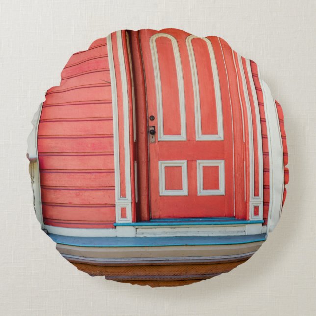 Traditional red painted wooden door and porchdoor, round cushion (Front)