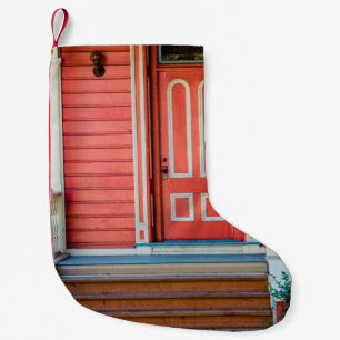 Traditional red painted wooden door and porchdoor, small christmas stocking