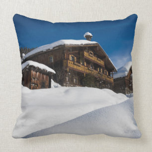 Traditional wooden cabins in de snow cushion