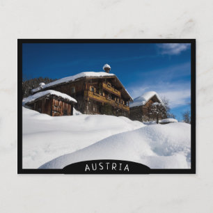 Traditional wooden cabins in de snow postcard