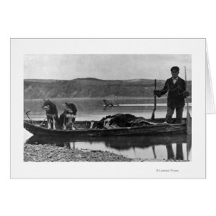Trapper in Canoe with Hides and Dogs Alaska