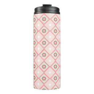 Travel mug with a pink and white geometric pattern
