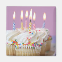 Tray of birthday cupcakes with candles