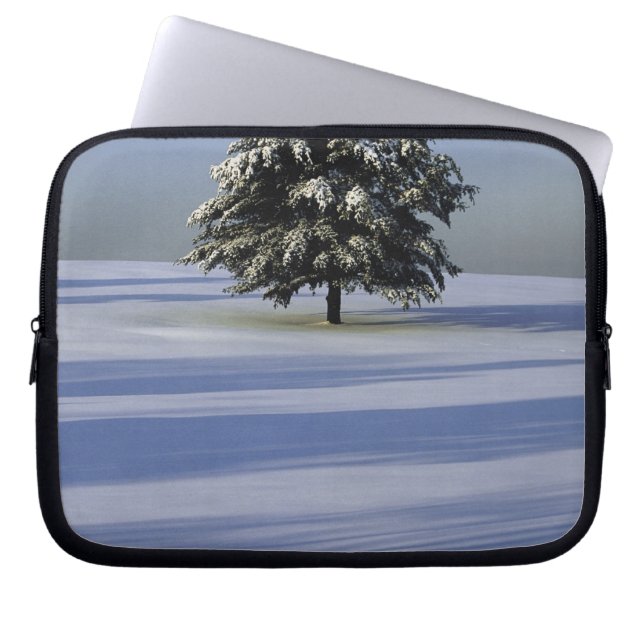Tree in snow covered landscape laptop sleeve (Front)