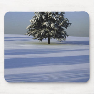 Tree in snow covered landscape mouse mat