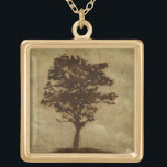 Tree Silhouette on Bronze Background Gold Plated Necklace<br><div class="desc">A bronze background serves as the scene for this silhouette of a tree with branches swaying in the breeze. You almost feel as if you could rest your back against this tree,  sit on the ground and take a long nap.</div>