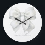 Trendy White Bow Personalised With Name Monogram Large Clock<br><div class="desc">Add a touch of elegance and personalisation to any space with the Trendy White Bow Personalised With Name Monogram Large Clock. This exquisite clock features a stylish white bow design, perfect for those who appreciate a trendy aesthetic and vintage charm. Ideal for a baby girl’s room, this clock enhances the...</div>