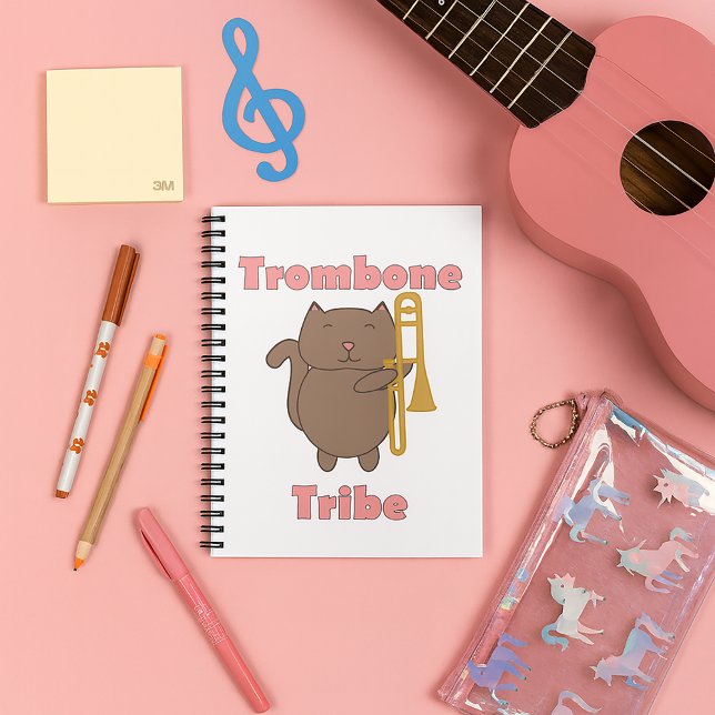 Trombone Tribe Kawaii Brown Cat Pink Letters Notebook (A notebook with a cute cat holding a trombone & the words trombone tribe in pink.)