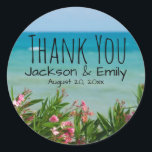 Tropical Beach Wedding Personalised Thank You Classic Round Sticker<br><div class="desc">Tropical pink flowers frame the beach and ocean. Thank You is written in a trendy. The bride and groom names and their wedding date is written below. Great for a tropical wedding,  beach wedding,  destination wedding or summer wedding.</div>