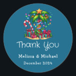 Tropical Christmas Palm Tree Thank You Classic Round Sticker<br><div class="desc">Thank you stickers with a seasonal holiday image. A tropical palm tree decorated in festive lights with a star on top. A giant red and white candy cane sticking out of the sand. Christmas presents under the tree. Whimsical and fun.</div>