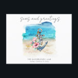Tropical Coastal Beach Christmas Holiday Card<br><div class="desc">Tropical Coastal Beach Christmas Holiday Card - Beachy Christmas Postcard features an anchor adorned with tropical flowers and silver bells with a watercolor beach background. Modern script typography reads " Seas and Greetings" and is personalised with your family name or business name with year and family member's names. The back...</div>