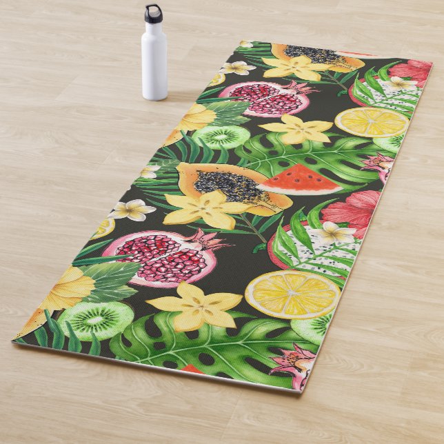 Tropical mix-fruit, flowers and leaves on black yoga mat (In Situ)
