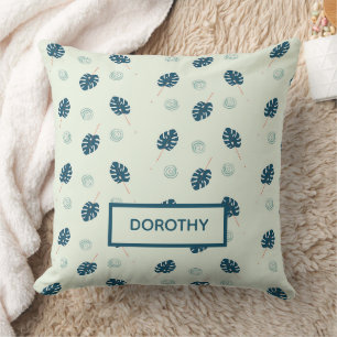 Tropical monstera leaves monogram on blue cushion