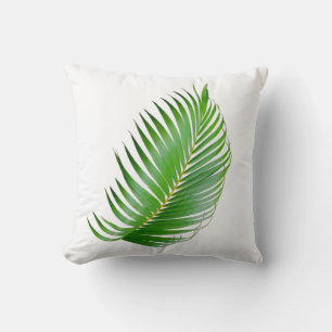 Tropical palm green leaf on white cushion