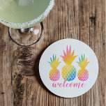 Tropical Pineapple Pink Rainbow Watercolor Welcome Coaster<br><div class="desc">Tropical style coaster features welcome in pink script overlapping three vibrant rainbow colored pineapples with a watercolor tie-dye gradient look. So chic for your vacation beach house or summer home decor.</div>