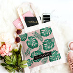 Tropical Pink & Green Palm Leaves Pattern & Name Tote Bag<br><div class="desc">The Tropical Pink & Green Palm Leaves pattern is a vibrant and lively design that incorporates elements of nature and a tropical aesthetic. The pattern features lush palm leaves in shades of pink and green, creating a striking contrast and an overall eye-catching appearance.Overall, the Tropical Pink & Green Palm Leaves...</div>