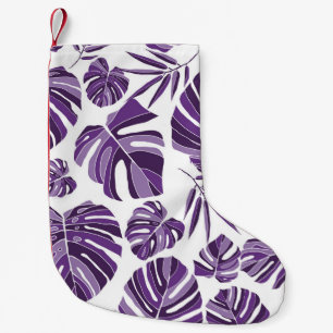 Tropical violet monstera leaves seamless pattern w small christmas stocking