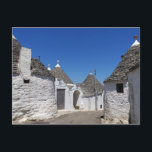 Trulli houses in Alberobello, Puglia postcard<br><div class="desc">Postcard of traditional white plaster trulli houses with stone tiles in conical roofs in a small street in the town Alberobello,  Itria Valley in Puglia,  Italy.</div>
