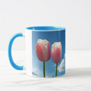 Tulips flowers in blue sky mug