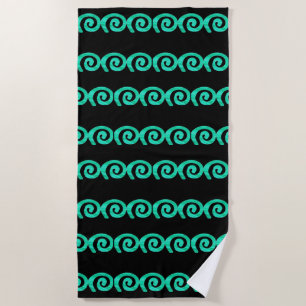 Turquoise and blue spirals pattern on black beach towel