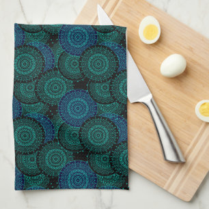 Turquoise blue round mandala on black background tea towel