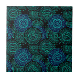 Turquoise blue round mandala on black background tile