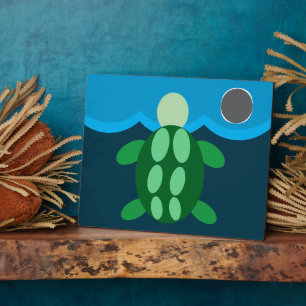 turtle swimming at midnight. plaque