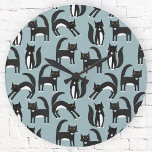 Tuxedo Black and White Cats Round Clock<br><div class="desc">Cute black and white tuxedo cats going about their business. A fun pattern on a mid blue background.  Original art by Nic Squirrell.</div>